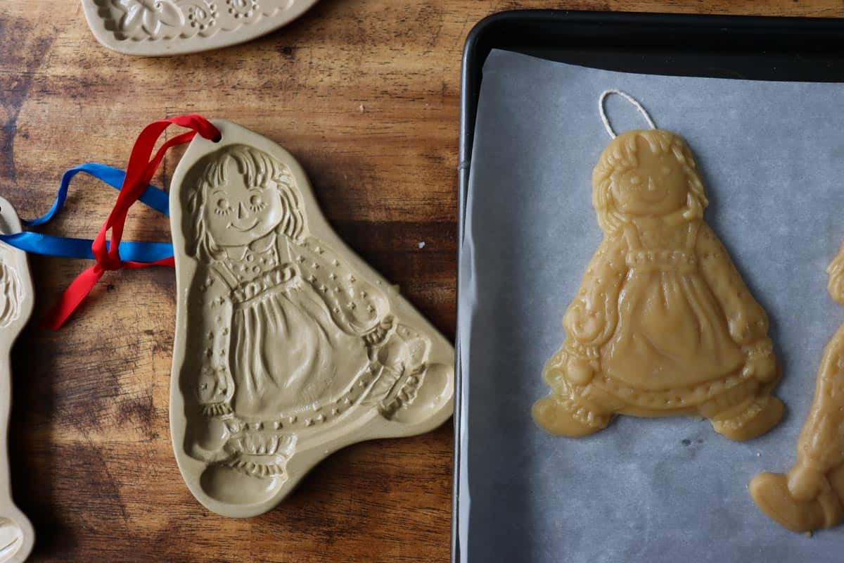 a side by side of the clay mold vs how the beeswax ornament looks out of it