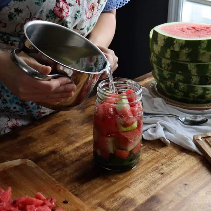 pouring brine over watermelon and other ingredients