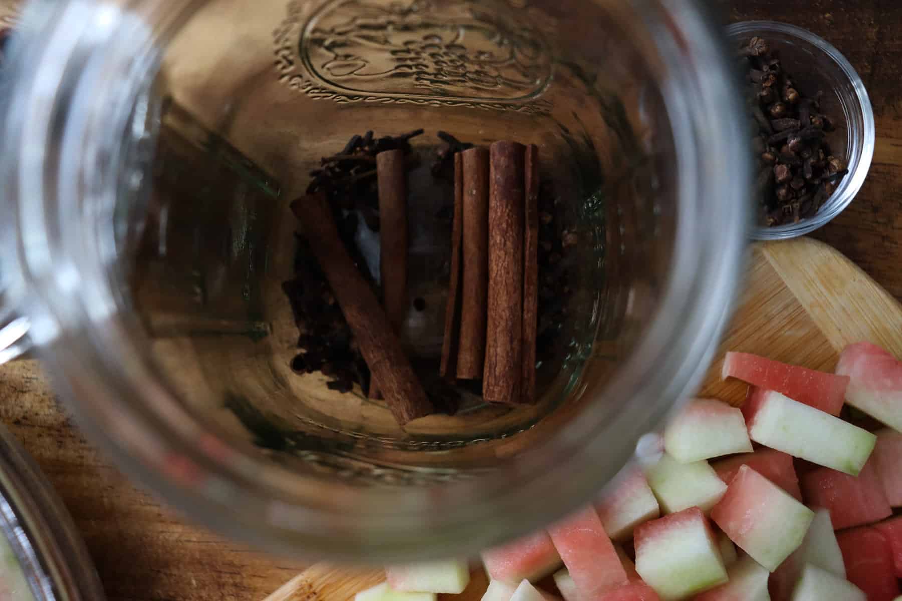 cinnamon sticks and whole cloves in a jar